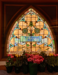 historic stained glass window that says First Lutheran Church
